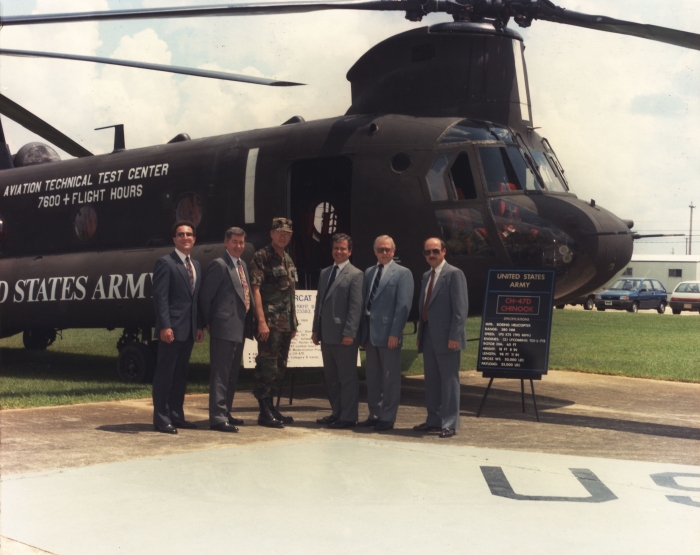 A photograph of CH-47D Chinook helicopter 81-23385 posing with some unknown individuals at an Aviation Technical Test Center (ATTC) ceremony.
