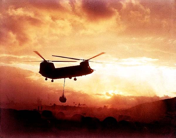 An A model Chinook belonging to the 228th ASHC transports a sling load in Vietnam.