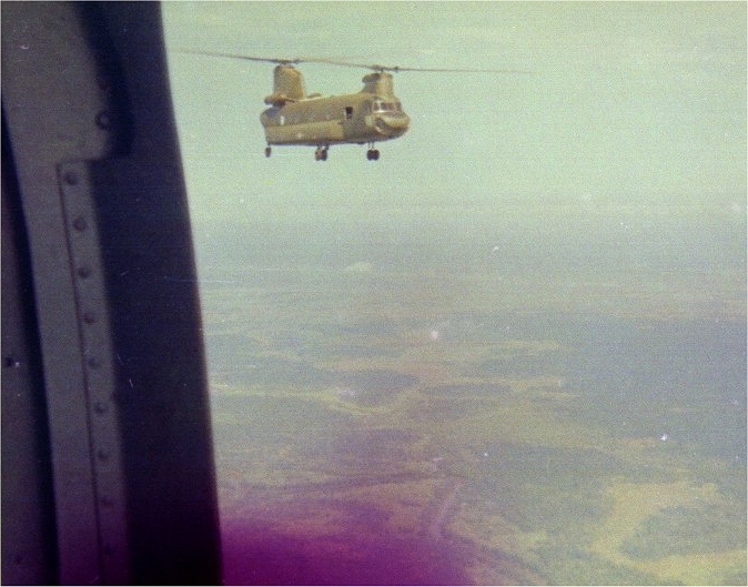 A photograph of CH-47A Chinook helicopter 66-19070 taken from a sister ship while conducting a mission in the Republic of Vietnam, circa 1972.
