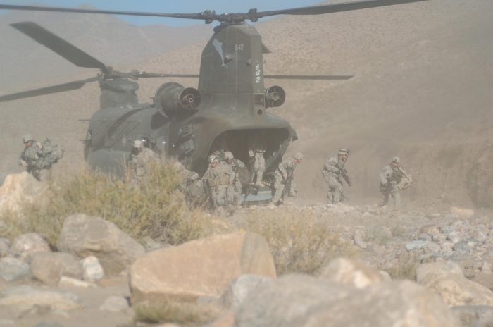 A combined team runs off CH-47D Chinook helicopter 86-01642 after landing near Landekhel Village, Kohe Sofi District, Parwan province, on a mission to destroy a weapons cache near the village.