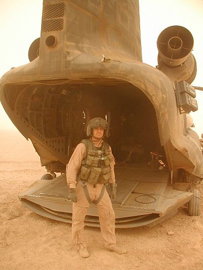 Chinook 88-00099 and Flight Engineer Lance E. Reynolds in the Iraqi desert, 2003.