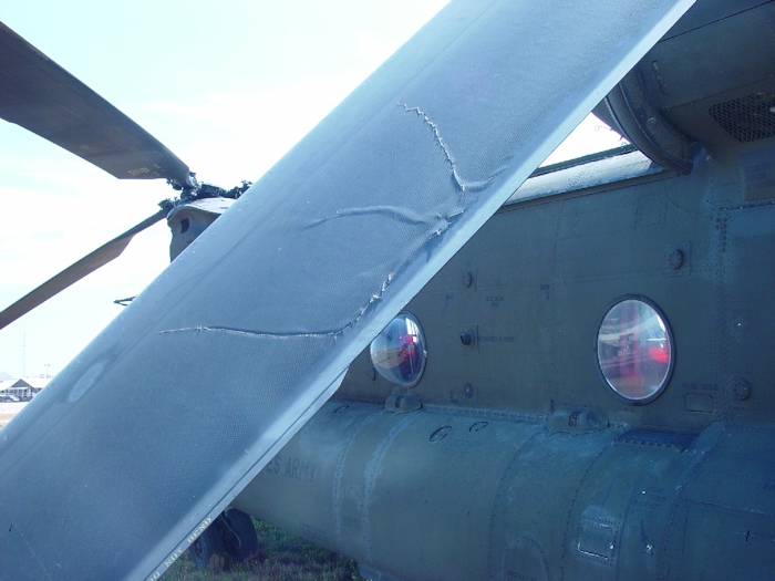 July 2002: This photograph shows extensive damage to an aft rotor blade. There are cracks and tears in the structure of the blade.