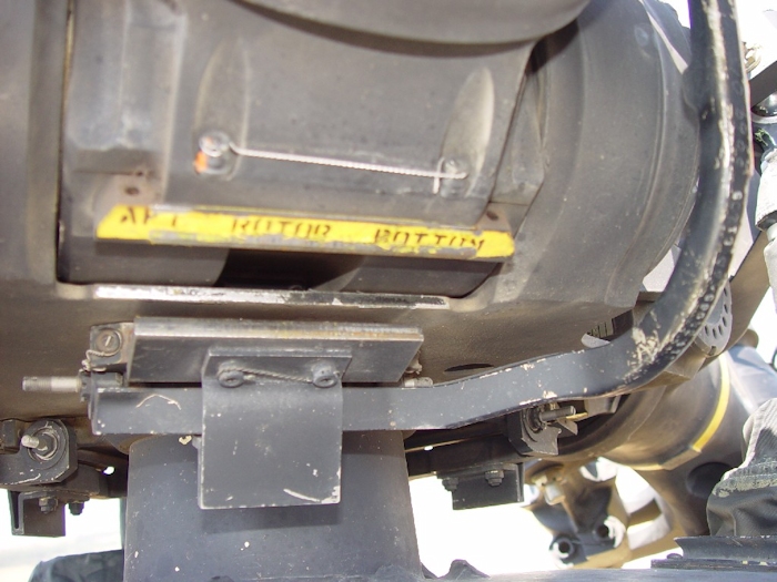 July 2002: The interposer block - the retangular piece of steel well below the yellow painted area - that would normally rest against the droop stop (the yellow painted hardware) and the rotor head hub, failed to engage during the accident sequence. When this happens, the aft rotor blades will droop down and make contact with the fuselage.