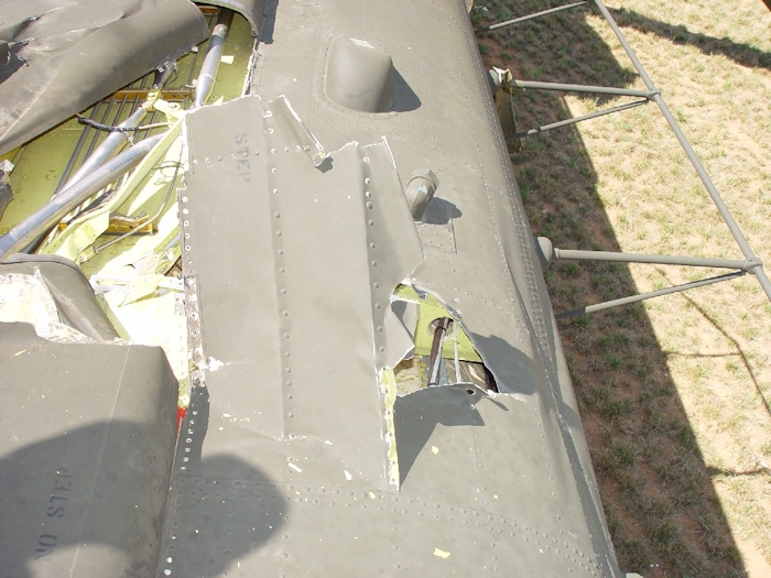 July 2002: When the aft green blade struck the fuselage it was moving right to left in this photograph. As contact was made the blade ripped through skin and dug in, severely damaging the flight control tubes leading to the aft rotor system and displacing the number one and two tunnel covers. At this point, the aircraft was no longer flyable.