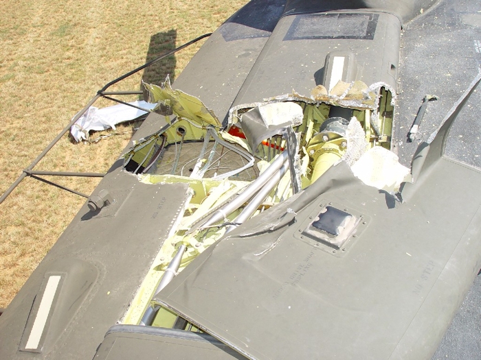 July 2002: When the aft green blade struck the fuselage it was moving left to right in this photograph. As contact was made the blade ripped through skin and dug in, severely damaging the flight control tubes leading to the aft rotor system and displacing the number one and two tunnel covers. At this point, the aircraft was no longer flyable.