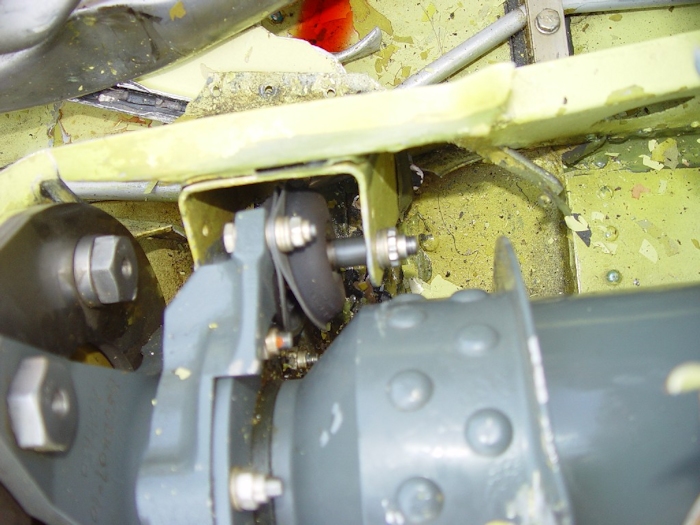 July 2002: A view of the sheet metal damage to the left (top is left) of the number two hanger bearing. A distorted lord mount is pictured in the center of the image.