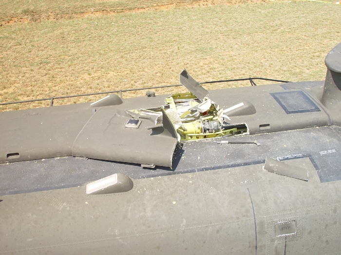 July 2002: A wider look at the damage to the airframe. The three forward formation lights can be seen. The number one tunnel cover has a single formation light mounted on the top. The number two tunnel cover was displaced and nearly removed from the airframe. Half a tunnel cover support strut can be seen to the right of the tunnel covers as well as debris from the number one tunnel cover just above the forward top step.