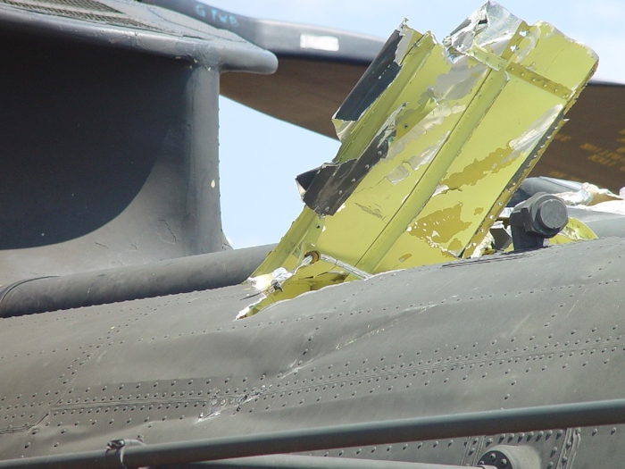 July 2002: A view from the left side of the fuselage showing the damage to the skin and structure during the blade strike.