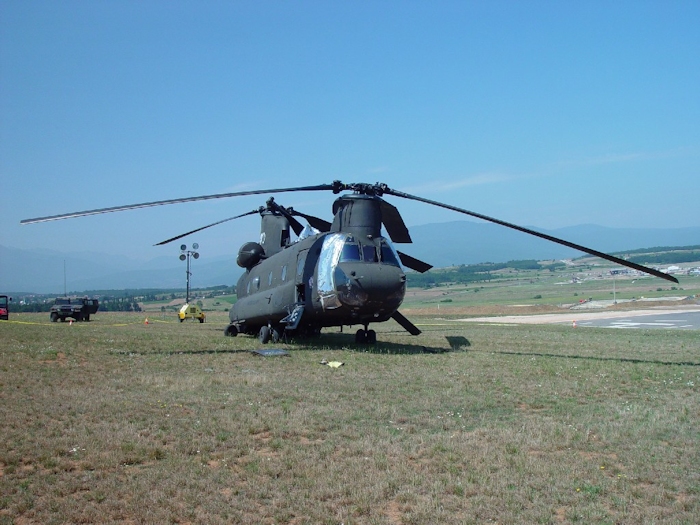 July 2002: Sitting in the grass at Camp Bondsteel, Serbia, this photograph shows 89-00138 in the days following the accident. Support personnel have covered the vunerable areas with protective barrier material to prevent further damage.