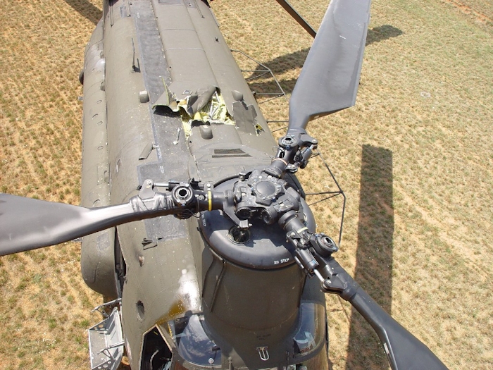 July 2002: A birds eye view of the top of the airframe. Oil can be seen dripping down on the right front side of the cockpit. More than likely a seal has blown on the forward rotor head.