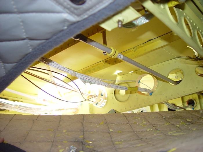 July 2002: A view from inside the main cabin below the number two hanger bearing where the aft green blade struck the fuselage. With the skin ripped from the airframe, a hole to outside world had developed.