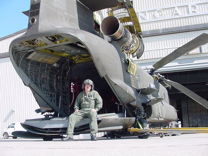 A photograph SSG Jonathon Oconner, Flight Engineer, sitting on the ramp of 89-00177 nearing the completion of Phase maintenance while assigned to the Sugar Bears at Fort Wainwright, Alaska, July 2002.