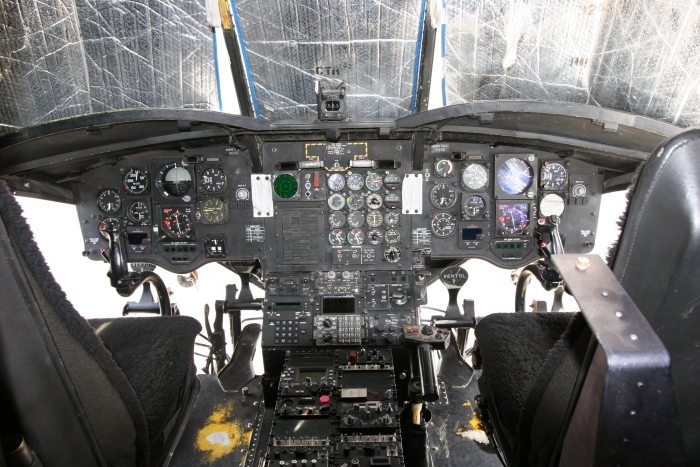 The cockpit of 91-00256. Visible on the dashboard are all of the flight instruments required to operate the helicopter. In the center console are the radio and navigation control heads used to communicate and navigate the aircraft.