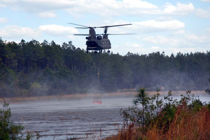20 June 2007: A CH-47 Chinook helicopter from Hunter Army Airfield in Savannah, Georgia., provides firefighting support in Flagler County, Florida, with a 2,000-gallon water bucket.