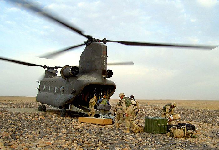 26 November 2003: Soldiers remove equipment from 92-00307, a CH-47D Chinook helicopter, at a remote firebase near Gereshk, Afghanistan. The soldiers are assigned to the 10th Mountain Division's 10th Forward Support Battalion.