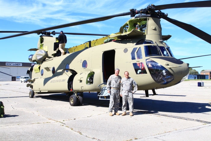 19 September 2012: 2-1 GSAB Battalion Commander LTC Hughes and Battalion Standardization Pilot CW4 Kyle Evans pose for a photograph beside 10-08802 at Gus Grissom Joint Civil/Military Air Reserve Base. CW4 Evarts rode as a passenger on 10-08802 while LTC Hughes rode on 10-08804 for the duration of the ferry flight to gain insight on how their new helicopters function. Net Team Flight Engineer Roy Payne is seen conducting a post-flight on the top of the aircraft.