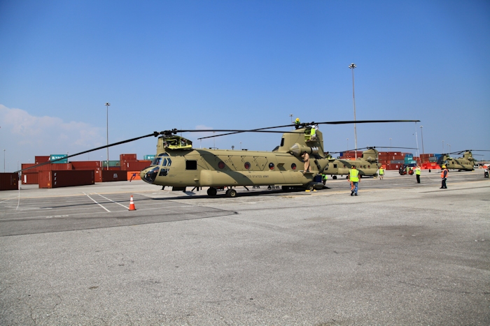 11 September 2013: CH-47F Chinook helicopter 11-08841 sits on the dock at the Port of Baltimore awaiting ship transport to the Republic of Korea. New Equipment Training Team mechanics employed by Boeing are gathering at the aircraft in preparation to remove the rotor blades and prepare the aircraft for shipboard loading.  NET Team Standardization Instructor Bill Cagle is completing the post flight inspection of the Number One Engine.