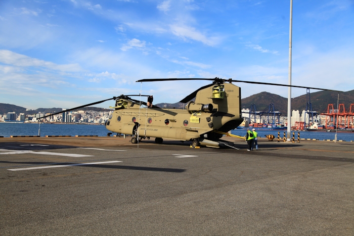 8 November 2013: Flight Engineer Wade Cothran inspects the top of the aircraft while Boeing Maintenance Team members load the last of the cargo aboard CH-47F Chinook helicopter 11-08841. This was the last CH-47F to leave the dock which required all remaining support equipment and personnel that did not have other transport arranged to be aboard.