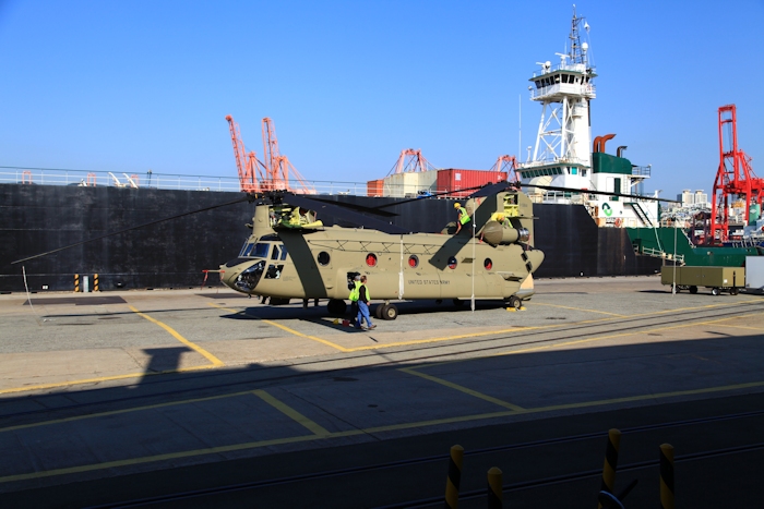 5 November 2013: CH-47F Chinook helicopter 11-08841 sits on the dock at Pier 8, Busan, Republic of Korea, as Boeing Maintenance Team members finish up work on installing the rotor blades.