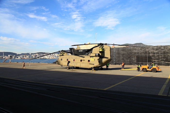 8 November 2013: Boeing Maintenance Team members prepare to tow 11-08841 onto the run-up pad at Pier 8, Busan, Republic of Korea. Jason Trombly, pilot, walks off to the left.
