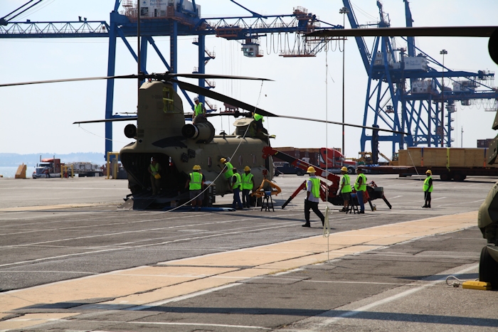 11 September 2013: CH-47F Chinook helicopter 11-08841 sits on the dock at the Port of Baltimore as Boeing Maintenance Team members work on removing the rotor blades to facilitate ship board loading.
