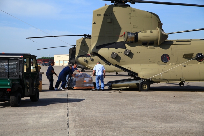 9 April 2012: Boeing maintenance personnel load some cargo aboard the Chinook helicopters in preparation for the ferry flight to Alaska.