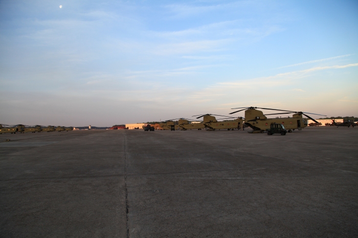 10 April 2012: First light strikes the Chinook helicopter fleet on Hunter Army Airfield as the ferry flight crews prepare the aircraft for departure.