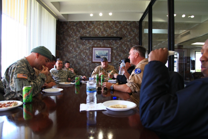 11 April 2012: Some of the Sortie 1 aircrews partake of the pizza delivered from Godfather's Pizza while at Sioux City, Iowa. Left to right around the table: CW4 Barcoe, Ken Scull, LTC Killen, Jason Jennings, Tom Miskoweic, Bobby Rhue, Tim McCall, CW4 Bruce Linton.