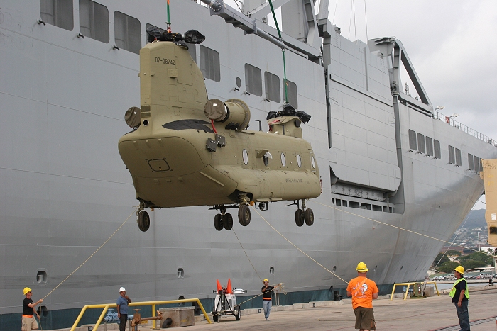 18 November 2010: CH-47F Chinook helicopter 07-08742 was the sixth aircraft to arrive at the dock. Manning the ropes were three of S3 Inc.'s Flight Engineer Standardization Instructors: Jason Sims (black shirt left), George Hall (black shirt center), and Robert Simpson (orange shirt).