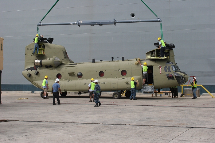 18 November 2010: CH-47F Chinook helicopter 07-08743 officially arrived in Hawaii as it was set down on the dock at Pearl Harbor. Boeing employees quickly set out to remove the sling to facilitate the unloading of more helicopters.