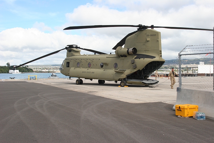 20 November 2010: With Matthew Nimmo, S3 Flight Engineer, close at hand, CH-47F Chinook helicopter 09-08065 is ready to go following reassembly and preflight. The USS Arizona Memorial can be seen in the distance.