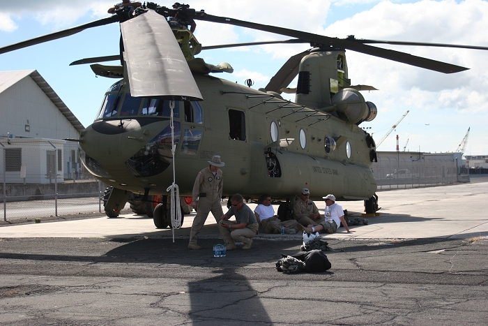 20 November 2010: The S3 NET Team aircrews await their chance to preflight as CH-47F Chinook helicopter 09-08068 gets some final maintenance during reassembly on the dock at Pearl Harbor.