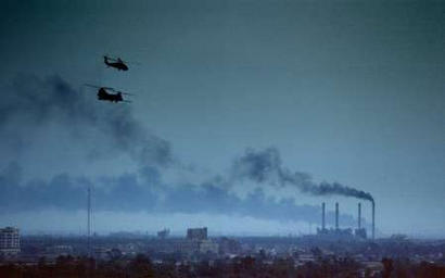 A U.S. Army MH-47E Chinook and Black Hawk helicopter fly over Baghdad.