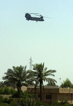 A U.S. CH-47D Chinook helicopter flies over Balad, some 40 miles (60 kms) north of Baghdad, Iraq on Friday, 27 June 2003. Three Iraqis are being interrogated after two soldiers and their Humvee were reported missing while guarding the perimeter of a rocket demolition site near the town of Balad. On Saturday, 28 June 2003, the bodies of the missing soldiers were discovered.