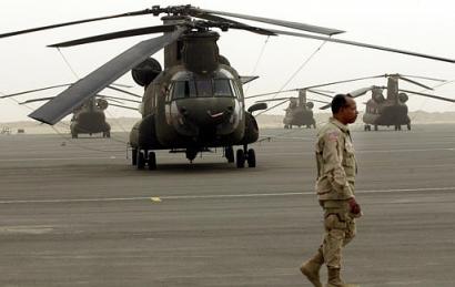 US Army Lt.Col. Leon Sumpter, from Indianapolis, Indiana, walks by a fleet of American CH-47D Chinook helicopters at Camp Arifjan, 80 Km south of Kuwait City on Sunday, 22 June 2003. Arifjan is considered the logistic center for the US troops deployed in the area of Kuwait and Iraq.