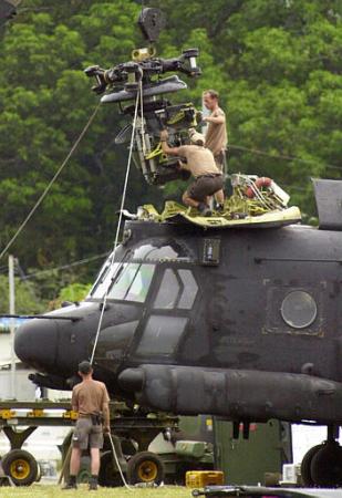 Removing the forward transmission from a MH-47E Chinook helicopter for air transport.