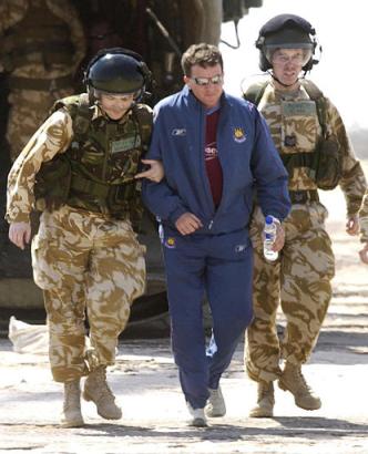 Released British hostage Gary Teeley, center, is helped by British service personnel from a Chinook helicopter on Monday, 12 April 2004, at 22 Field Hospital based in Shaibah, Iraq on his first full day of freedom after being held hostage by Iraqi militia. Teeley had been in Iraq working as a laundry firm consultant for a Qatar-based company when he was snatched from the southern city of Nasiriyah last Monday and was held until his release to Italian troops early Sunday.