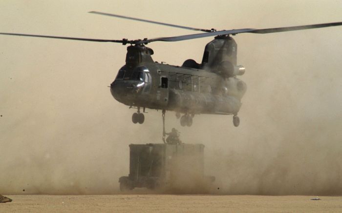 An unknown CH-47 Chinook helicopter slings a commo van during an unknown mission, at an unknown location, and on an unknown date.