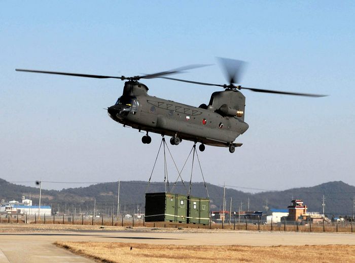 A CH-47D Chinook helicopter equipped with Honeywell GA-714A engines drops off troops, vehicles and additional supplies at Kunsan Air Base, South Korea.